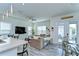 Open-concept living room with hardwood-style floors and seamless flow from kitchen to dining space at 11309 Grand Park Ave, Riverview, FL 33578