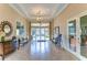 Inviting lobby with tile floors, chandelier, seating, and glass doors to welcome residents and guests at 11309 Grand Park Ave, Riverview, FL 33578
