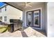 Covered patio with stone pavers features a stainless grill and view of the backyard at 11309 Grand Park Ave, Riverview, FL 33578