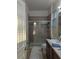 Clean bathroom featuring a tiled shower with glass doors, and a vanity with storage at 11527 Southern Creek Dr, Gibsonton, FL 33534