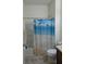 Well-maintained bathroom with a shower-tub combo and a decorative ocean-themed shower curtain at 11527 Southern Creek Dr, Gibsonton, FL 33534