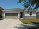 Charming single-story home featuring a two-car garage and a well-maintained front yard at 11527 Southern Creek Dr, Gibsonton, FL 33534