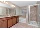 This bathroom features a double sink vanity, soaking tub, and glass-enclosed shower at 12310 Streambed Dr, Riverview, FL 33579