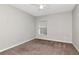 This bedroom has neutral walls, a window, a ceiling fan, and neutral color carpet at 12310 Streambed Dr, Riverview, FL 33579