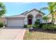 Well maintained single-story home featuring a lush lawn, mature landscaping and modern architectural details at 12310 Streambed Dr, Riverview, FL 33579