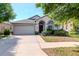Charming single-story home with a well-manicured lawn and a welcoming facade at 12310 Streambed Dr, Riverview, FL 33579