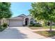 Charming single-story home with a well-manicured lawn and a welcoming facade at 12310 Streambed Dr, Riverview, FL 33579