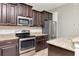 Close-up of kitchen showcasing stainless steel appliances and granite countertops at 12310 Streambed Dr, Riverview, FL 33579
