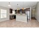 Open kitchen featuring stainless steel appliances, stylish dark cabinetry and tile flooring at 12310 Streambed Dr, Riverview, FL 33579
