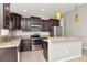 Well-equipped kitchen featuring stainless steel appliances, granite countertops, and stylish pendant lighting at 12310 Streambed Dr, Riverview, FL 33579