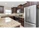 Spacious kitchen featuring granite countertops and stainless steel refrigerator at 12310 Streambed Dr, Riverview, FL 33579