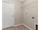 This laundry room has tile floors and a white door at 12310 Streambed Dr, Riverview, FL 33579