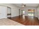 Open living room showcasing a mix of tile and wood flooring and a vaulted ceiling at 12310 Streambed Dr, Riverview, FL 33579