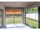 Enclosed screened porch with a view of the green lawn and backyard at 12310 Streambed Dr, Riverview, FL 33579