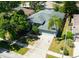 Aerial view of home highlighting roof, circular windows, two car garage, and driveway at 12920 Lake Ventana Dr, Tampa, FL 33625