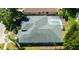 Aerial view of home showcasing roof, screened pool, and placement on the lot at 12920 Lake Ventana Dr, Tampa, FL 33625