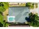 Aerial view of home showcasing the roof, screened pool enclosure, and landscaping at 12920 Lake Ventana Dr, Tampa, FL 33625