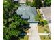 Aerial view of home highlighting the roof, driveway, and lawn at 12920 Lake Ventana Dr, Tampa, FL 33625