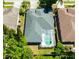 Aerial view of home showcasing the roof, screened pool enclosure, and surrounding trees at 12920 Lake Ventana Dr, Tampa, FL 33625