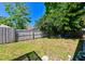 Fenced backyard featuring a mix of grassy and shady areas and mature landscaping at 12920 Lake Ventana Dr, Tampa, FL 33625