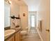 Bright bathroom with a toilet, shower, and vanity, leading to an outside view through the glass door at 12920 Lake Ventana Dr, Tampa, FL 33625