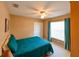 Comfortable bedroom with a ceiling fan, double door closet, and a large window for natural light at 12920 Lake Ventana Dr, Tampa, FL 33625