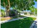 Beautiful single-story home with a lush lawn and mature trees, creating a serene and inviting curb appeal at 12920 Lake Ventana Dr, Tampa, FL 33625
