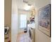 Well-organized laundry room featuring a washer, dryer, storage shelves, and bright natural light at 12920 Lake Ventana Dr, Tampa, FL 33625