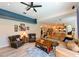 Inviting living room with blue accent wall, comfortable seating, and open layout to dining area at 12920 Lake Ventana Dr, Tampa, FL 33625