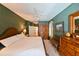 Cozy main bedroom with textured green walls, classic furnishings, and ample natural light at 12920 Lake Ventana Dr, Tampa, FL 33625