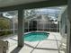 Enclosed pool provides a serene retreat, complete with a shaded patio and a view of the surrounding landscape at 12920 Lake Ventana Dr, Tampa, FL 33625