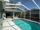 A refreshing screened-in pool featuring a sun-drenched deck, perfect for relaxation and outdoor entertainment at 12920 Lake Ventana Dr, Tampa, FL 33625