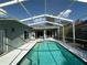 Screened-in pool with a sparkling blue water and ample deck space for lounging and outdoor enjoyment at 12920 Lake Ventana Dr, Tampa, FL 33625