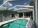 Enclosed pool area offers privacy and relaxation, with a clear view of the home's exterior at 12920 Lake Ventana Dr, Tampa, FL 33625