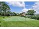Community basketball court surrounded by lush trees, offering a space for recreation and fitness at 13008 Eagles Entry Dr, Odessa, FL 33556