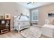 Charming bedroom with daybed, crib, neutral walls, and area rug at 13008 Eagles Entry Dr, Odessa, FL 33556