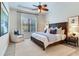 A light and airy main bedroom features a large bed, neutral walls, and a ceiling fan at 13008 Eagles Entry Dr, Odessa, FL 33556