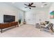 Bright bedroom with cozy seating, a ceiling fan, and natural light, offering a comfortable retreat at 13008 Eagles Entry Dr, Odessa, FL 33556