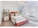 Cozy bedroom with a pink velvet headboard, white desk, and ample natural light at 13008 Eagles Entry Dr, Odessa, FL 33556