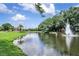 Scenic view of a lake with a fountain, part of the amenities in The Eagles community at 13008 Eagles Entry Dr, Odessa, FL 33556