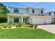 Beautiful two-story home with a three-car garage and landscaped front yard at 13008 Eagles Entry Dr, Odessa, FL 33556
