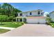 Two-story home with manicured lawn and brick paver driveway at 13008 Eagles Entry Dr, Odessa, FL 33556