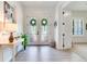 Bright foyer featuring double doors, a console table, and elegant decor at 13008 Eagles Entry Dr, Odessa, FL 33556