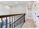 Upper hallway with carpeted floor, white trim, and dark hardware providing access to other rooms at 13008 Eagles Entry Dr, Odessa, FL 33556