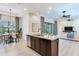 Kitchen with dark wood cabinets, stainless steel appliances, island with barstool seating, and dining area at 13008 Eagles Entry Dr, Odessa, FL 33556