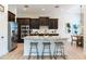 Kitchen with stainless steel appliances, an island with barstool seating, and a sink at 13008 Eagles Entry Dr, Odessa, FL 33556