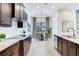 Open kitchen with stone countertops, stainless steel appliances, and adjacent dining area at 13008 Eagles Entry Dr, Odessa, FL 33556