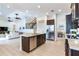 Open kitchen with an island and stainless steel appliances adjacent to a dining area and living room at 13008 Eagles Entry Dr, Odessa, FL 33556