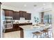 Stylish kitchen featuring granite counters, stainless steel appliances, and a breakfast bar with bar stools at 13008 Eagles Entry Dr, Odessa, FL 33556