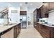 Kitchen featuring dark wood cabinets, stainless steel appliances, and island with barstool seating at 13008 Eagles Entry Dr, Odessa, FL 33556